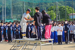 岡谷南高校クラスマッチの表彰式。各種目で入賞したクラスの代表者が、朝礼台の上で賞状を受け取る様子。