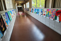 岡谷南高校の校舎廊下の壁一面に掲示された、色とりどりの個性豊かなクラス演劇や展示の宣伝ポスター。