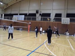 岡谷南高校の体育館にて、声を掛け合いながらサーブやレシーブを繋ぐ女子バレーボールの様子